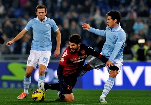 Lazio&#039;s Senad Lilic (left) and Anderson Hernanes and Cagliari&#039;s defender Luca Rossettini on January 5, 2013 in Rome