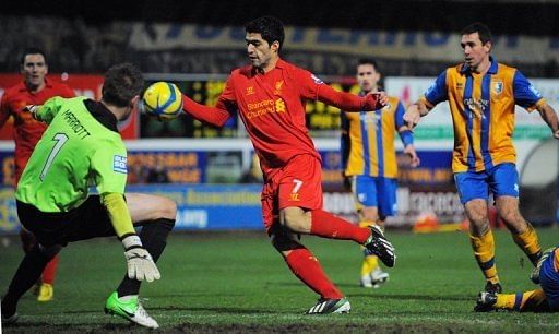 Liverpool&#039;s Luis Suarez (C) appears to stop the ball with his hand during the game against Mansfield on January 6, 2013