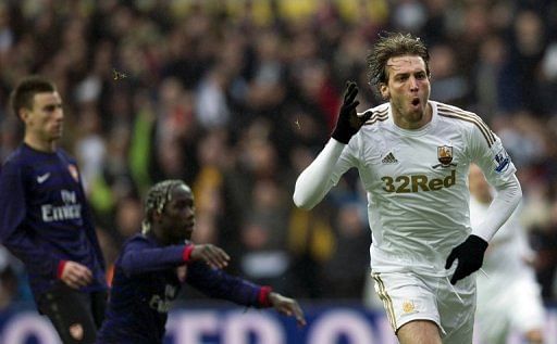 Swansea City&#039;s Michu (R) celebrates after scoring the opening goal against Arsenal in the FA Cup on January 6, 2013