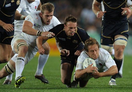 Mike Blair (centre) challenges England&#039;s Jonny Wilkinson (right) in a World Cup game in Auckland on October 1, 2011