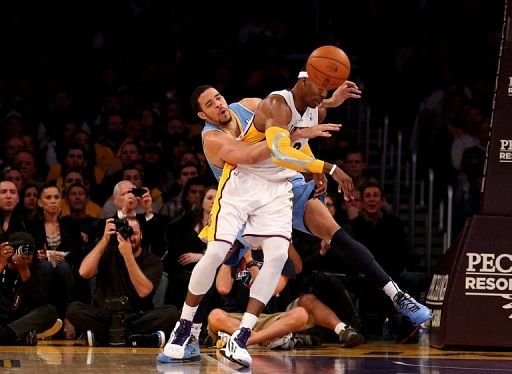 JaVale McGee of the Denver Nuggets knocks the ball away from Dwight Howard of the Los Angeles Lakers on January 6, 2013