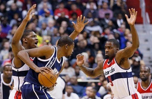 Washington Wizards&#039; Martell Webster (R) pressure Kevin Durant of Oklahoma City during their game on January 7, 2013