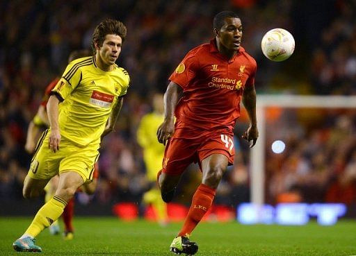 Liverpool&#039;s Andre Wisdom (R) escapes from Anzhi Makhachkala&#039;s Fyodor Smolov at Anfield on October 25, 2012