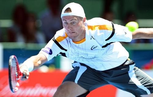 Lleyton Hewitt hits a backhand return against Tomas Berdych at the Kooyong Classic in Melbourne on January 10, 2013