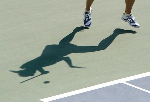 A shadow shows Maria Sharapova of Russia during the Pan Pacific Open tennis tournament in Tokyo on September 28, 2011