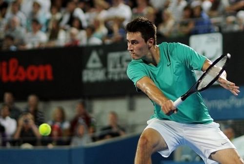 Bernard Tomic of Australia returns a shot against Jarkko Nieminen of Finland in Sydney on January 10, 2013