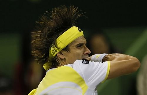 David Ferrer returns the ball to Nikolay Davydenko during their semi-final of the Qatar Open on January 4, 2013