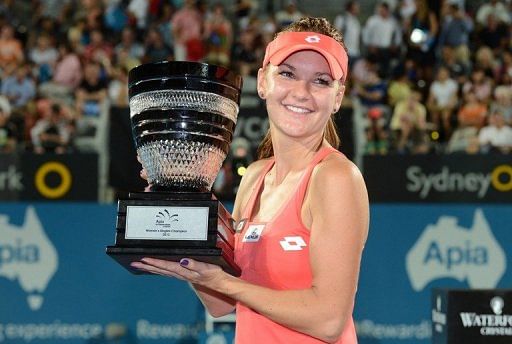 Agnieszka Radwanska holds her trophy after defeating Dominika Cibulkova in Sydney on Jan 11, 2013