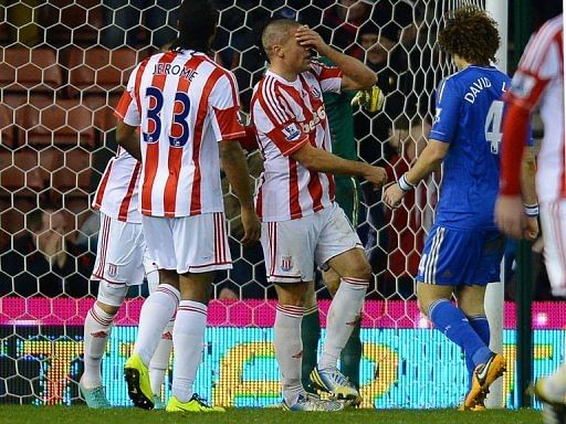 Stoke City&#039;s forward Jon Walters (C) reacts after missing a penalty in Stoke-on-Trent on January 12, 2013