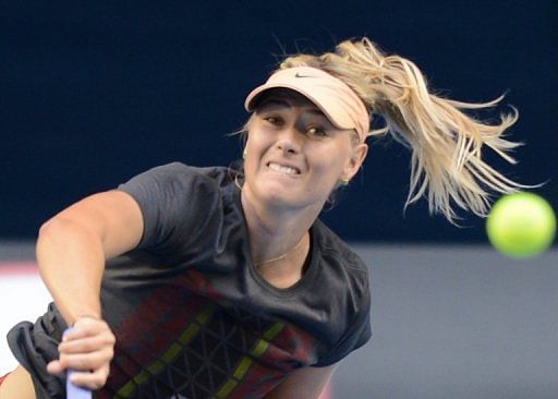 Russia&#039;s Maria Sharapova serves during a practice session ahead of the Australian Open on January 13, 2013