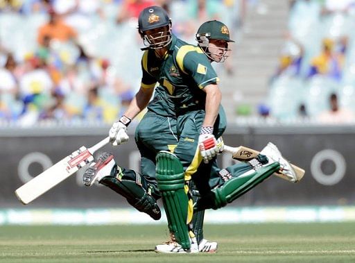 Phillip Hughes and captain George Bailey run between the wickets on January 11, 2013