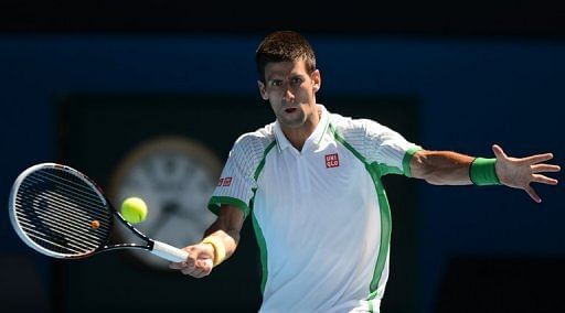 Novak Djokovic plays a return during his match against on the first day of the Australian Open on January 14, 2013
