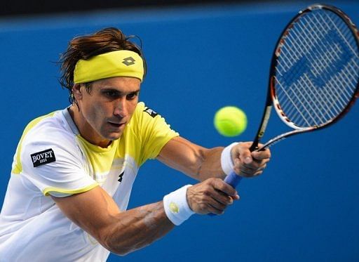 David Ferrer hits a return against Olivier Rochus (unseen) at the Australian Open in Melbourne on January 14, 2013