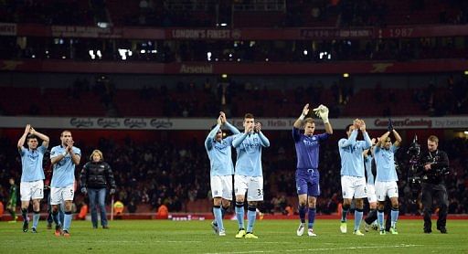 Manchester City players applaud their fans after winning at Arsenal 2-0 on January 13, 2013
