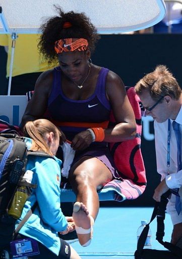 Serena Williams receives treatment during her first-round match at the Australian Open in Melbourne on January 15, 2013