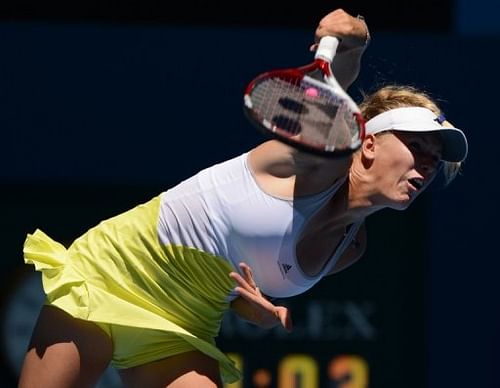 Denmark's Caroline Wozniacki serves to Germany's Sabine Lisicki at the Australian Open on January 15, 2013