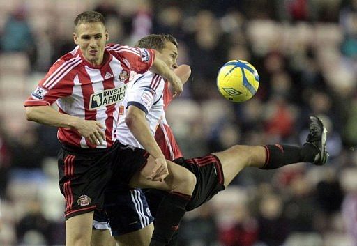 Sunderland defender Matt Kilgallon (L) battles with Bolton striker Kevin Davies on January 15, 2013