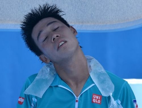 Kei Nishikori uses an ice pack during his match against Carlos Berlocq at the Australian Open on January 16, 2013