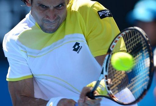 Spain&#039;s David Ferrer plays a return during his match against Tim Smyczek at the Australian Open on January 16, 2013