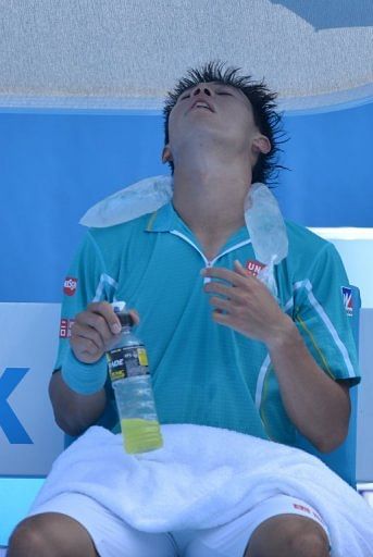 Japan's Kei Nishikori uses an ice pack during a break in his match at the Australian Open on January 16, 2013