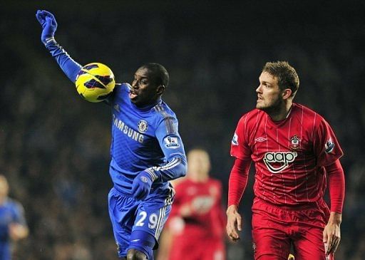 Demba Ba (L) shields the ball from Jos Hooiveld during the Premier League clash at Stamford Bridge on January 16, 2013