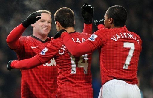 Wayne Rooney (L) celebrates scoring the only goal in the FA Cup third-round replay at Old Trafford on January 16, 2013