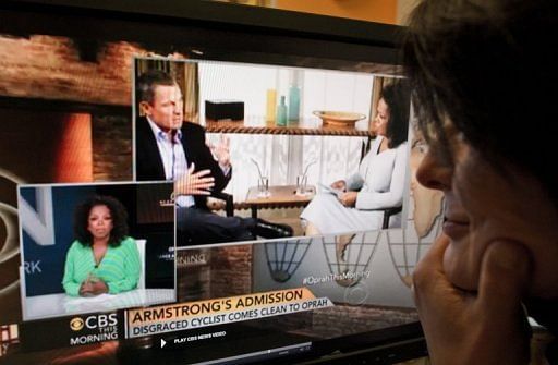 A woman watches the CBS morning show featuring TV presenter Oprah Winfrey, Washington DC, January 15, 2013
