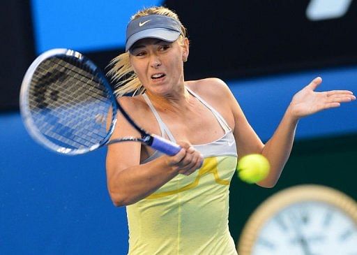 Maria Sharapova hits a return to Venus Williams during their Australian Open third round match on January 18, 2013