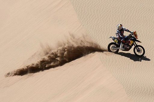 KTM&#039;s rider Cyril Despres of France looks behind during the Stage 12 of the Dakar Rally on January 17, 2013
