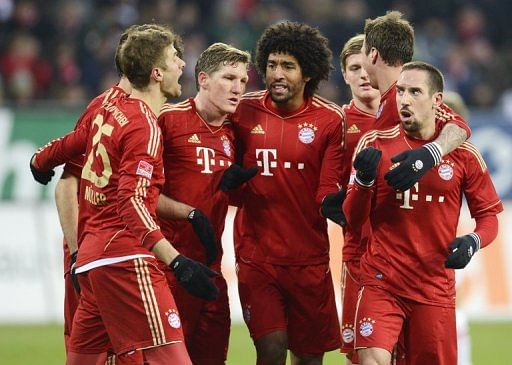 Bayern Munich&#039;s players celebrate scoring a goal against Augsburg, on December 8, 2012