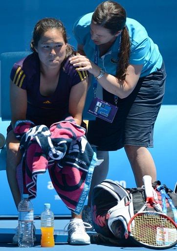 Jamie Hampton receives treatment during her match against Victoria Azarenka, in Melbourne, on January 19, 2013