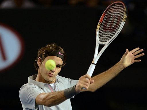 Roger Federer plays a return to Bernard Tomic in the Australian Open in Melbourne on January 19, 2013