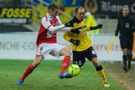 Reims' midfielder Antoine Devaux (L) challenges Sochaux' midfielder Sebastien Roudet on January 19, 2013