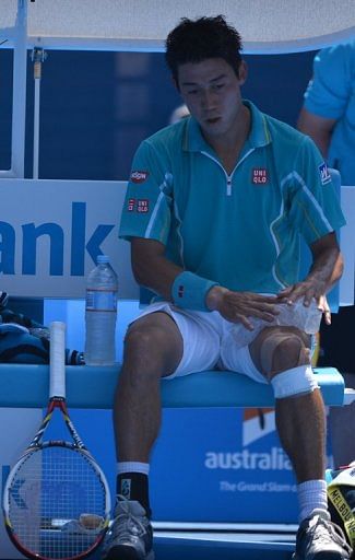 Kei Nishikori uses an ice-pack during his match at the Australian Open in Melbourne on January 20, 2013.