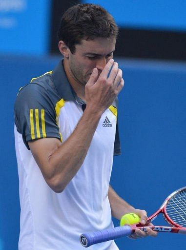 Gilles Simon reacts during his men&#039;s singles match against Andy Murray at the Australian Open on January 21, 2013