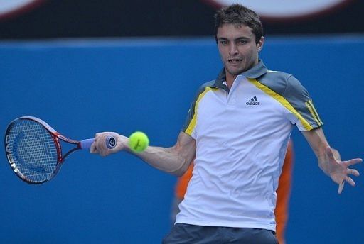 Gilles Simon hits a return against Andy Murray during their Australian Open match in Melbourne on January 21, 2013