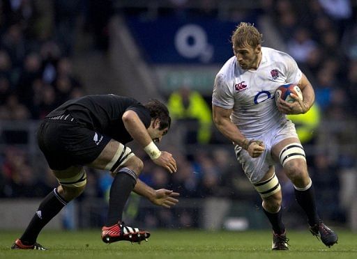 All Black Sam Whitelock (L) attempts a tackle on Chris Robshaw at Twickenham, on December 1, 2012