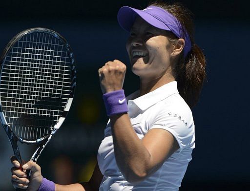 Li Na celebrates during her Australian Open singles match against Agnieszka Radwanska in Melbourne on January 22, 2013