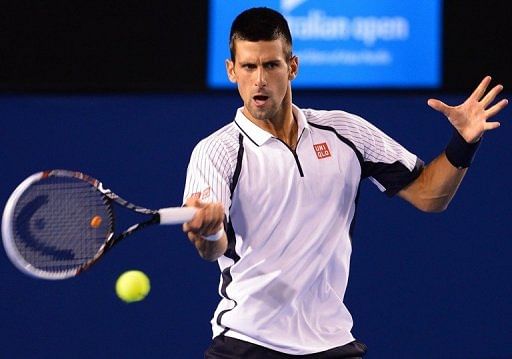 Novak Djokovic hits a return against Tomas Berdych during their Australian Open match in Melbourne on January 22, 2013