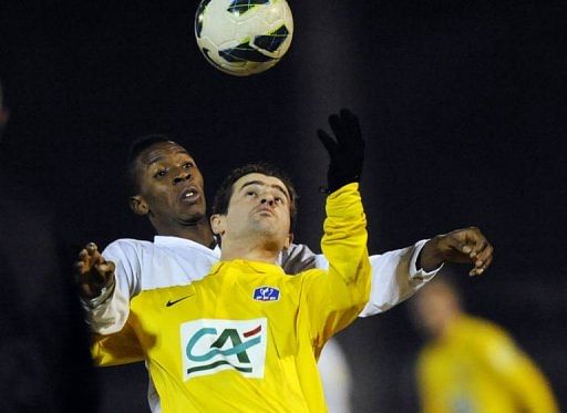 Epinal&#039;s Romain Chouleur (R) clashes with Nantes&#039; Birama Toure on January 22, 2013 in Epinal