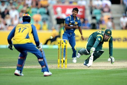 Phil Hughes (right) avoids being run out by Nuwan Kulasekara (centre) during a match in Hobart on January 23, 2013