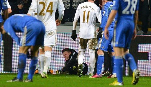 A ballboy (C) lies on the ground after altercation with Eden Hazard in Cardiff, south Wales, on January 23, 2012