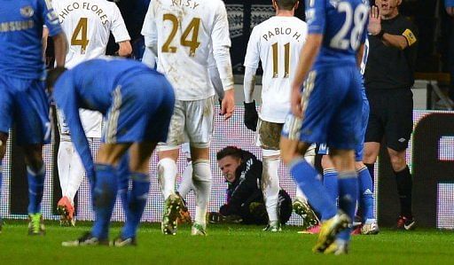 A ball boy lies on the ground after an altercation with Chelsea&#039;s Eden Hazard on January 23, 2013