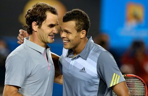 Roger Federer (L) embraces  Jo-Wilfried Tsonga after their match at the Australian Open in Melbourne on January 23, 2013
