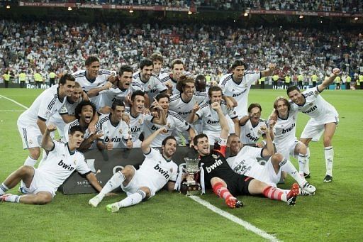 Real Madrid&#039;s players pose celebrate their victory 2-1 over Barcelona on August 29, 2012