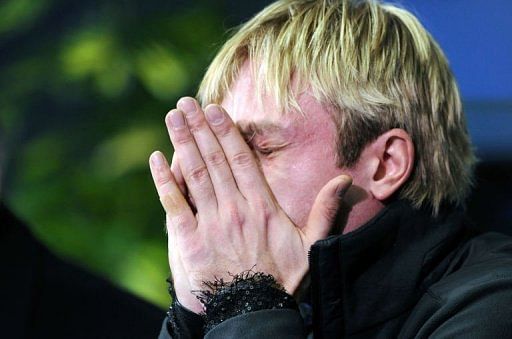 Evgeni Plushenko of Russia reacts after performing his men short program routine in Zagreb on January 24, 2013
