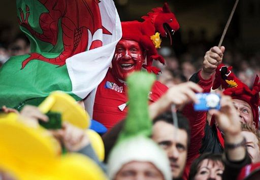 Welsh rugby fans celebrate after a Six Nations International rugby union match in Cardiff, Wales, on March 17, 2012