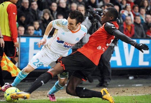 Marseille&#039;s midfielder Mathieu Valbuena (L)clashes with Rennes&#039;defender Chris Mavinga on January 26, 2013 in Rennes