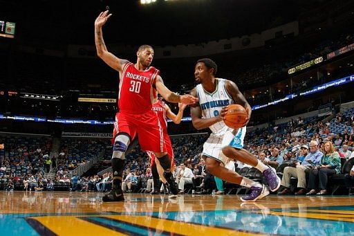 Roger Mason Jr. of the Hornets drives around Royce White of the Houston Rockets in a pre-season game on October 24, 2012