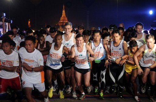 Runners are seen at the start of Myanmar&#039;s first international marathon in decades, in Yangon on January 27, 2013